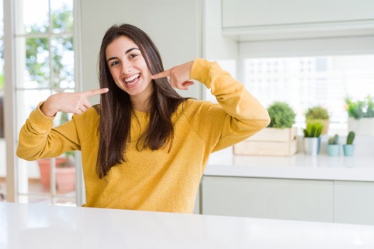 Teen pointing to her teeth
