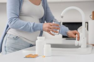 Pregnant woman taking prenatal vitamins